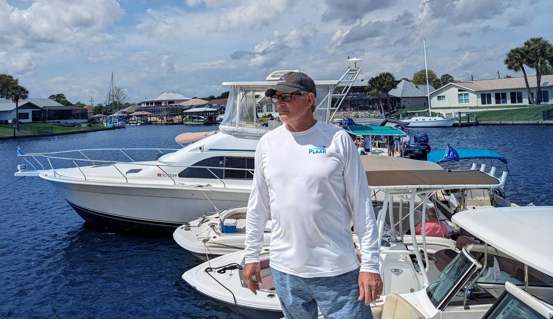 Man in white shirt standing on boat