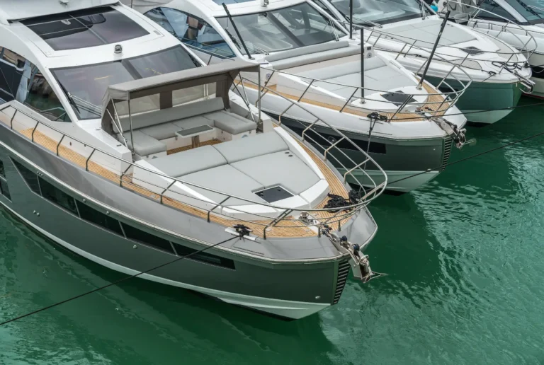 Silver motor yacht with foredeck sunpad and canopy